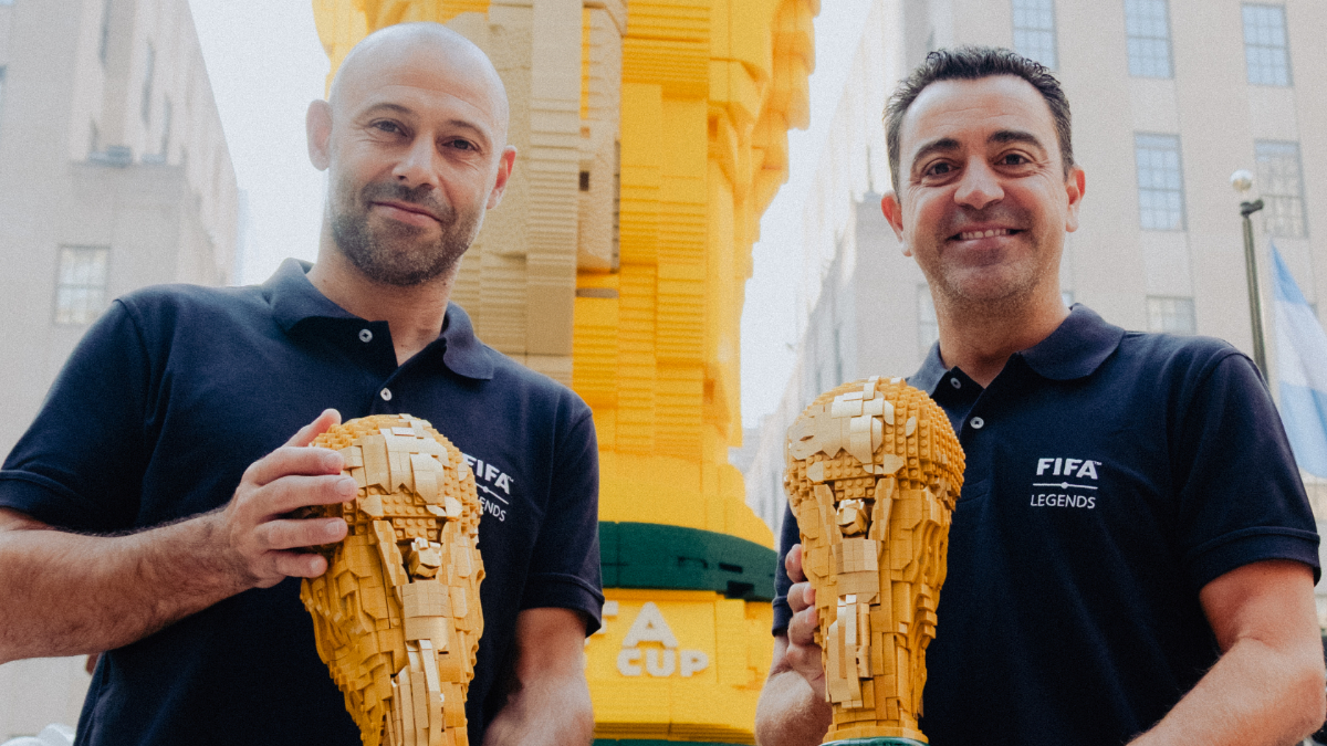 Xavi Hernández and Javier Mascherano with LEGO World Cup trophies